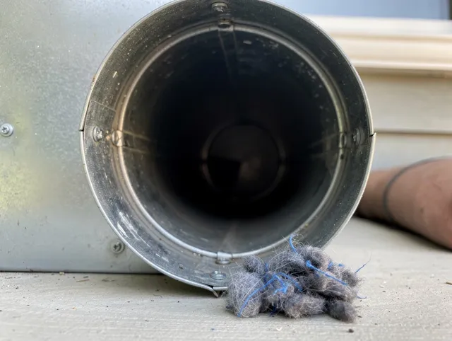 Rehoboth Dryer Vent Cleaning technician using specialized equipment to clear severe dryer vent blockage in Rehoboth